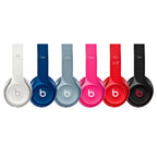 Set of six Beats headphones in different colors on a white background