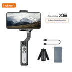 The image shows a black Hohem iSteady XE 3 Axis Handheld Gimbal Stabilizer with accessories, including a phone clamp, a USB cable, and a carrying case.
