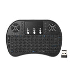 Black wireless keyboard with touchpad and USB receiver on a white background